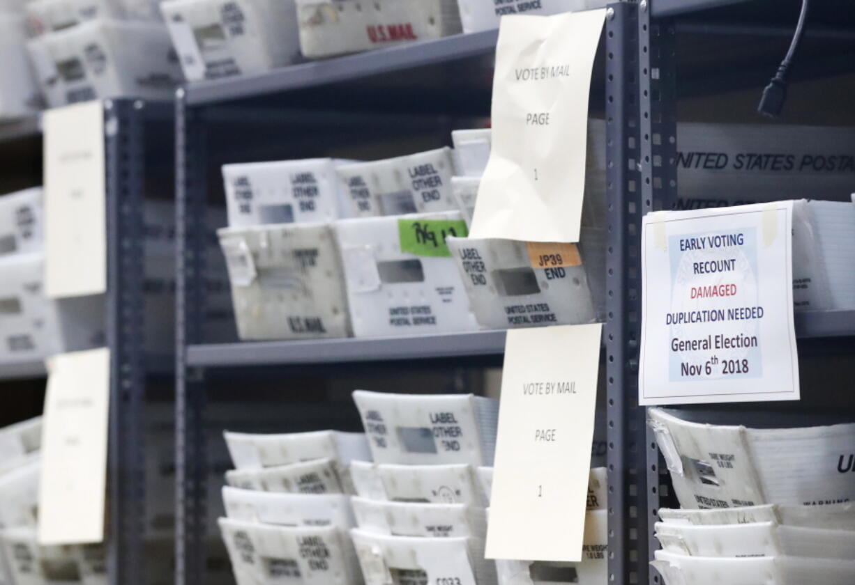 Bins filled with ballots are stacked at the Broward County Supervisor of Elections office as employees count ballots during a recount Wednesday in Lauderhill, Fla.