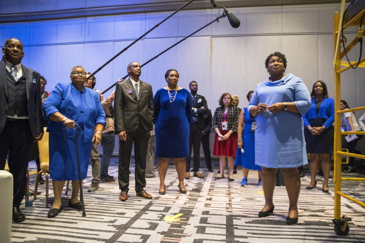 Georgia gubernatorial candidate Stacey Abrams, right, waits backstage with her family and friends before speaking to a crowd of supporters during her election night watch party at the Hyatt Regency in Atlanta on Wednesday. Georgia’s hotly contested and potentially historic governor’s race may not be over yet, with Democrat Abrams and Republican Brian Kemp awaiting the final accounting of absentee and provisional ballots.