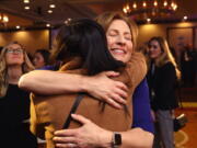 On election night Kim Schrier, facing camera, who is running for the 8th Congressional District, hugs a supporter at a victory party for Democrats on Tuesday in Bellevue.