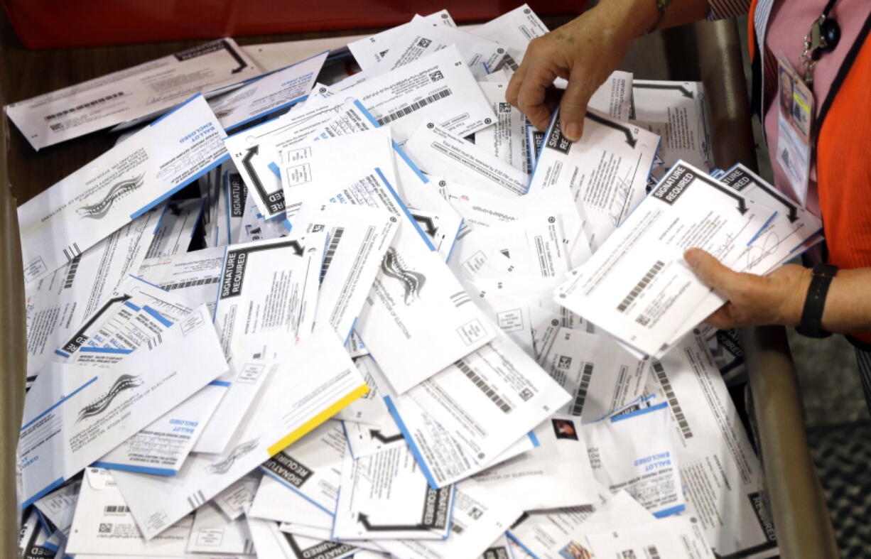 Ballots are prepared for counting May 17, 2016, at the Multnomah County election headquarters in Portland.