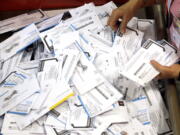 Ballots are prepared for counting May 17, 2016, at the Multnomah County election headquarters in Portland.