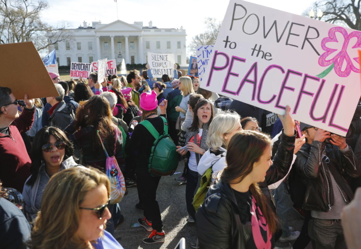 Women’s March demonstrators walk past the White House on Jan. 20 in Washington.