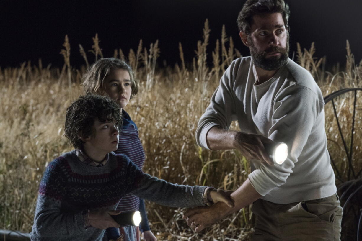 This image released by Paramount Pictures shows Noah Jupe, from left, Millicent Simmonds and John Krasinski in a scene from “A Quiet Place.” The film is a mostly silent horror film about a family trying to live among creatures that attack and kill at the smallest sound. It became a surprise box office phenomenon when it was released in theaters in April, grossing $338.6 million in worldwide ticket sales off a production budget of only $17 million. A sequel is already in the works.