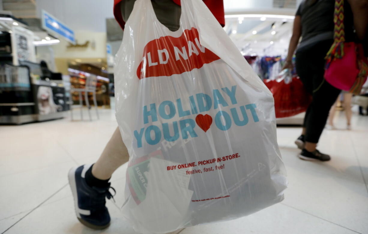 A Black Friday shopper walks through Dolphin Mall on Friday, Nov. 23, 2018, in Miami. Retailers are offering much of their Black Friday deals online, but shoppers still showed up at malls and stores around the country looking for discounts, and to take in the scene.