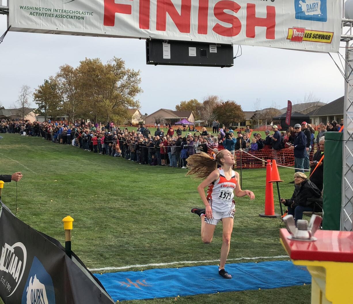 Washougal senior Amelia Pullen crosses the finish line to win the Class 2A race at the WIAA State Cross Country Championships on Saturday in Pasco.