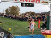 Washougal senior Amelia Pullen crosses the finish line to win the Class 2A race at the WIAA State Cross Country Championships on Saturday in Pasco.