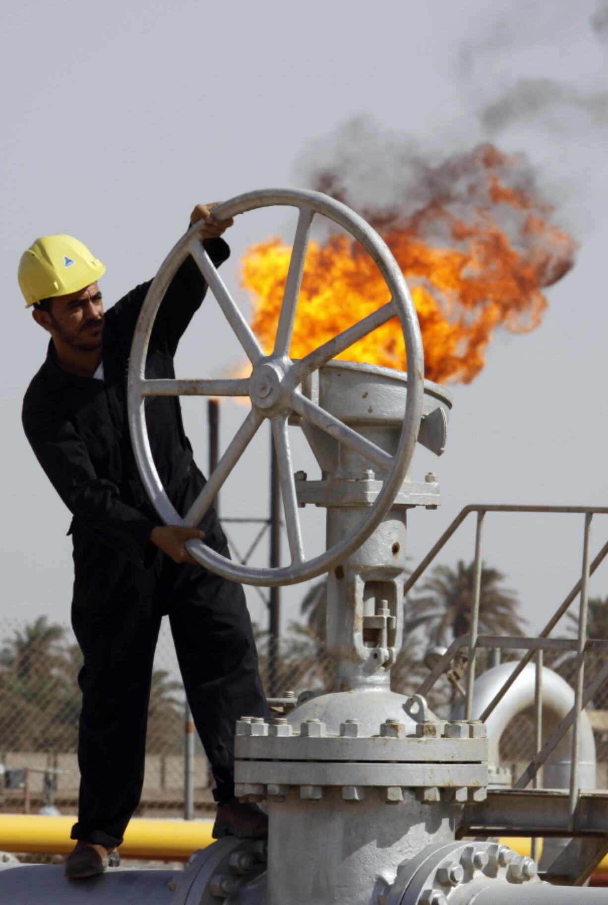 An Iraqi worker operates valves at the Nahran Omar oil refinery in Zubair near the city of Basra southeast of Baghdad, Iraq. Iraq’s Oil Ministry says Iraq has resumed exports from its oil fields around Kirkuk, one year after the city was seized by federal forces from the autonomous Kurdish administration in the north of the country.