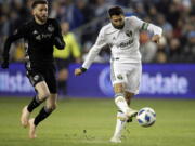 Portland Timbers midfielder Diego Valeri (8) shoots on net ahead of Sporting Kansas City midfielder Ilie Sanchez, left, during the first half in the second leg of the MLS soccer Western Conference championship in Kansas City, Kan., Thursday, Nov. 29, 2018.