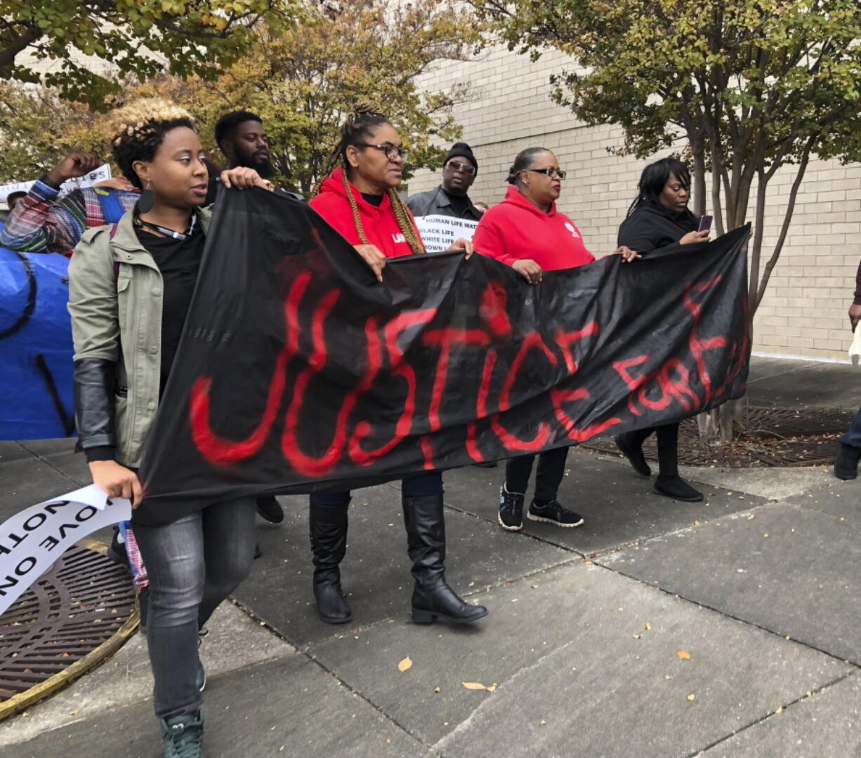 Protestors carry a sign reading “Justice for E.J.” during a protest at the Riverchase Galleria in Hoover, Ala., on Saturday. A police shot and killed 21-year-old Emantic Fitzgerald Bradford, Jr. of Hueytown while responding to a shooting at the mall on Thanksgiving evening. Police said Bradford was fleeing the scene with a weapon. Hoover police initially told reporters Bradford had shot a teen at the mall, but later retracted the statement.