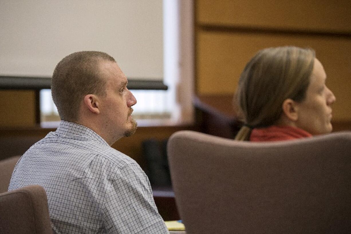 Todd Marjama, left, who is accused of killing his wife, listens to opening statements at the Clark County Courthouse on Tuesday morning.