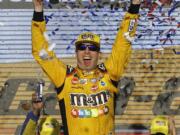 Kyle Busch (18) celebrates after winning a NASCAR Cup Series auto race on Sunday, Nov. 11, 2018, in Avondale, Ariz.