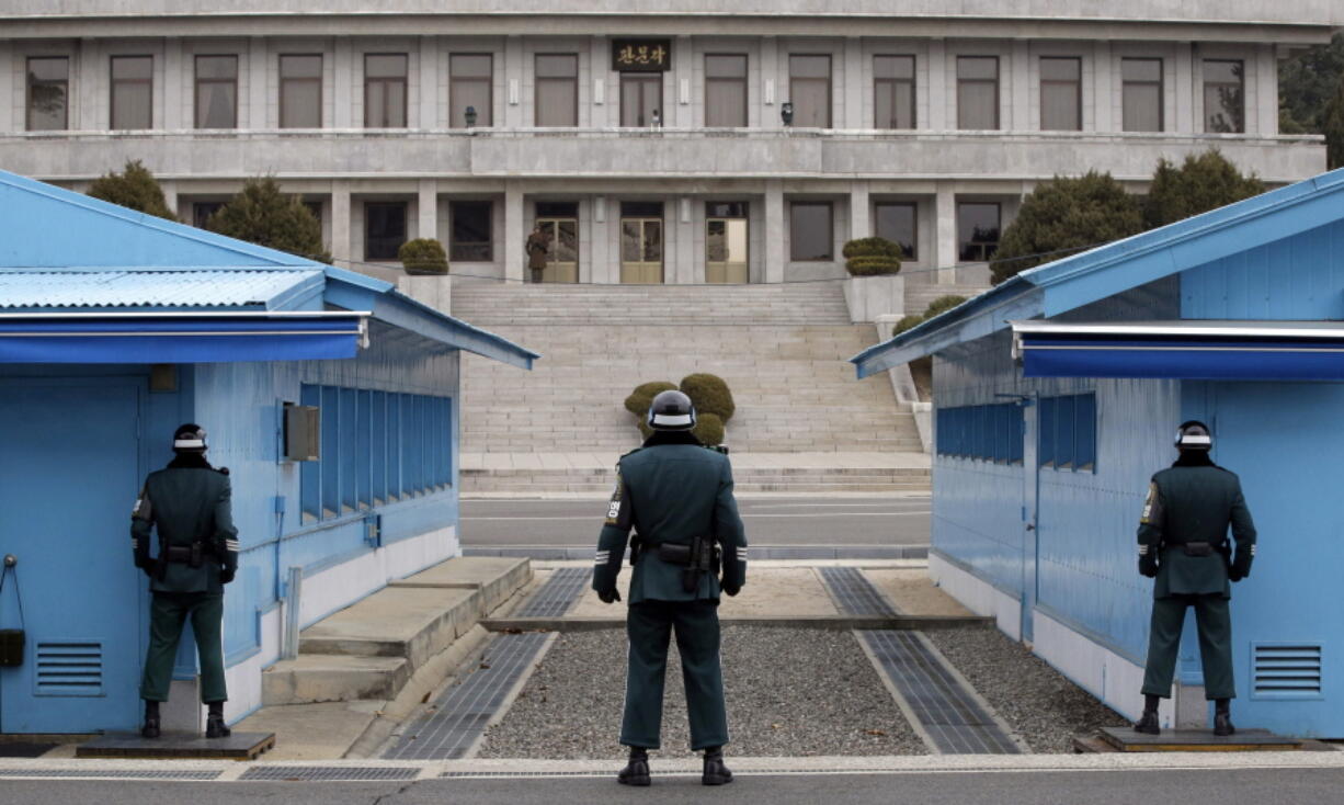 A North Korean soldier, center top, looks at the southern side as three South Korean soldiers guard at the border village of Panmunjom, which has separated the two Koreas since the Korean War, in Paju, South Korea. North Korea said Friday, Nov. 16, 2018, that it will deport an American citizen it detained for illegally entering the country recently, as the country’s state media said leader Kim Jong Un supervised a test of a newly developed high-tech weapon in an apparent bid to employ pressure on Washington and Seoul.