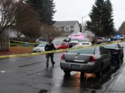 A sheriff’s deputy approaches the scene of a deputy-involved shooting Wednesday morning in the Orchards area. The Clark County Sheriff’s Office said a deputy was rammed by a stolen vehicle suspect.