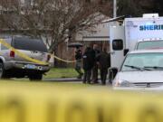 Investigators gather at the scene of a deputy-involved shooting Wednesday morning in the Orchards area. A deputy was rammed by a vehicle theft suspect and a shooting occurred.