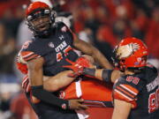 Utah quarterback Jason Shelley (15) is hosted in the air by teammates after scoring against Oregon in the second half during an NCAA college football game Saturday Nov. 10, 2018, in Salt Lake City.