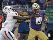 After spending more than half the season recovering from knee surgery in June, Washington’s Hunter Bryant (19) has provided a boost for the 10th-ranked Huskies’ offense this season.