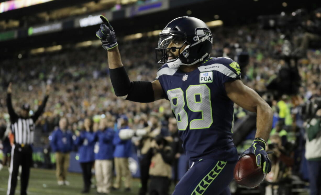 Seattle Seahawks wide receiver Doug Baldwin celebrates after catching a pass for a touchdown against the Green Bay Packers during the first half of an NFL football game Thursday, Nov. 15, 2018, in Seattle.