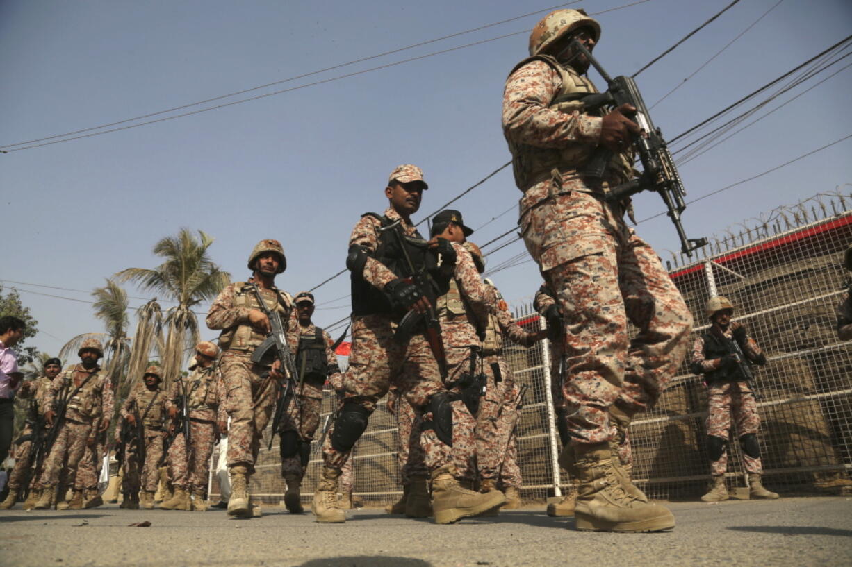 Pakistani troops move in the compound of Chinese Consulate in Karachi, Pakistan, on Friday. Pakistani police say gunmen have stormed the Chinese Consulate in the country’s southern port city of Karachi, triggering an intense shootout.