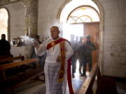 Christian militiamen stand guard in 2017 during Easter mass in Qaraqosh, outside Mosul, Iraq. Synagogues, mosques, churches and other houses of worship are routinely at risk of attack in many parts of the world. And so worshippers themselves often feel the need for visible, tangible protection even as they seek the divine.