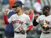 Boston Red Sox right fielder Mookie Betts, front left, and center fielder Jackie Bradley Jr., right, greet teammates after a win over the Detroit Tigers in a baseball game, Sunday, July 22, 2018, in Detroit.