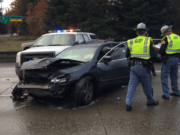 Troopers investigate a three-vehicle crash involving a trooper on a traffic stop.