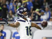 Seattle Seahawks wide receiver Tyler Lockett reacts after his 24-yard reception for a touchdown during the first half of an NFL football game against the Detroit Lions, Sunday, Oct. 28, 2018, in Detroit.