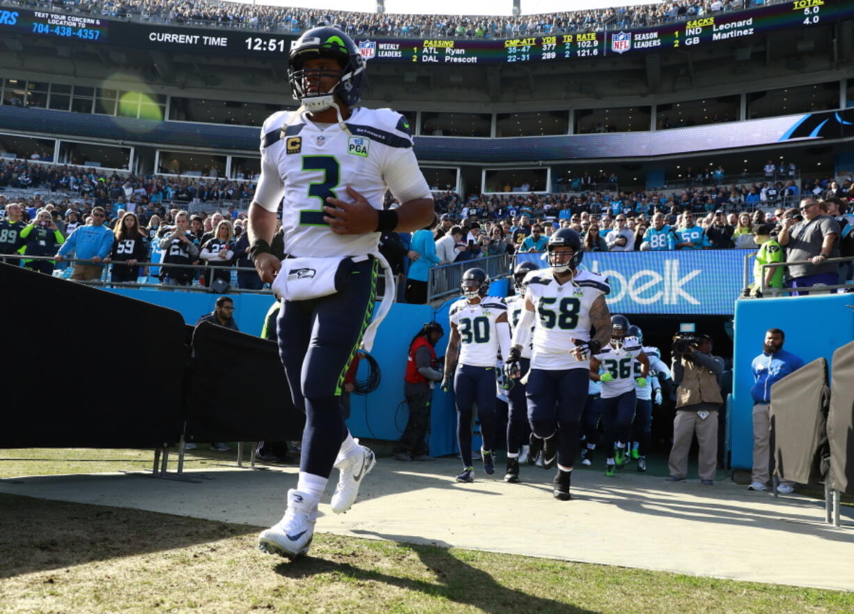 Seattle Seahawks’ Russell Wilson (3) leads his team onto the field before an NFL football game against the Carolina Panthers in Charlotte, N.C., Sunday, Nov. 25, 2018. (AP Photo/Jason E.