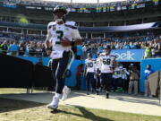 Seattle Seahawks’ Russell Wilson (3) leads his team onto the field before an NFL football game against the Carolina Panthers in Charlotte, N.C., Sunday, Nov. 25, 2018. (AP Photo/Jason E.