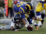 Los Angeles Rams defensive end Dante Fowler forces a fumble against the Seattle Seahawks during the second half in an NFL football game Sunday, Nov. 11, 2018, in Los Angeles.