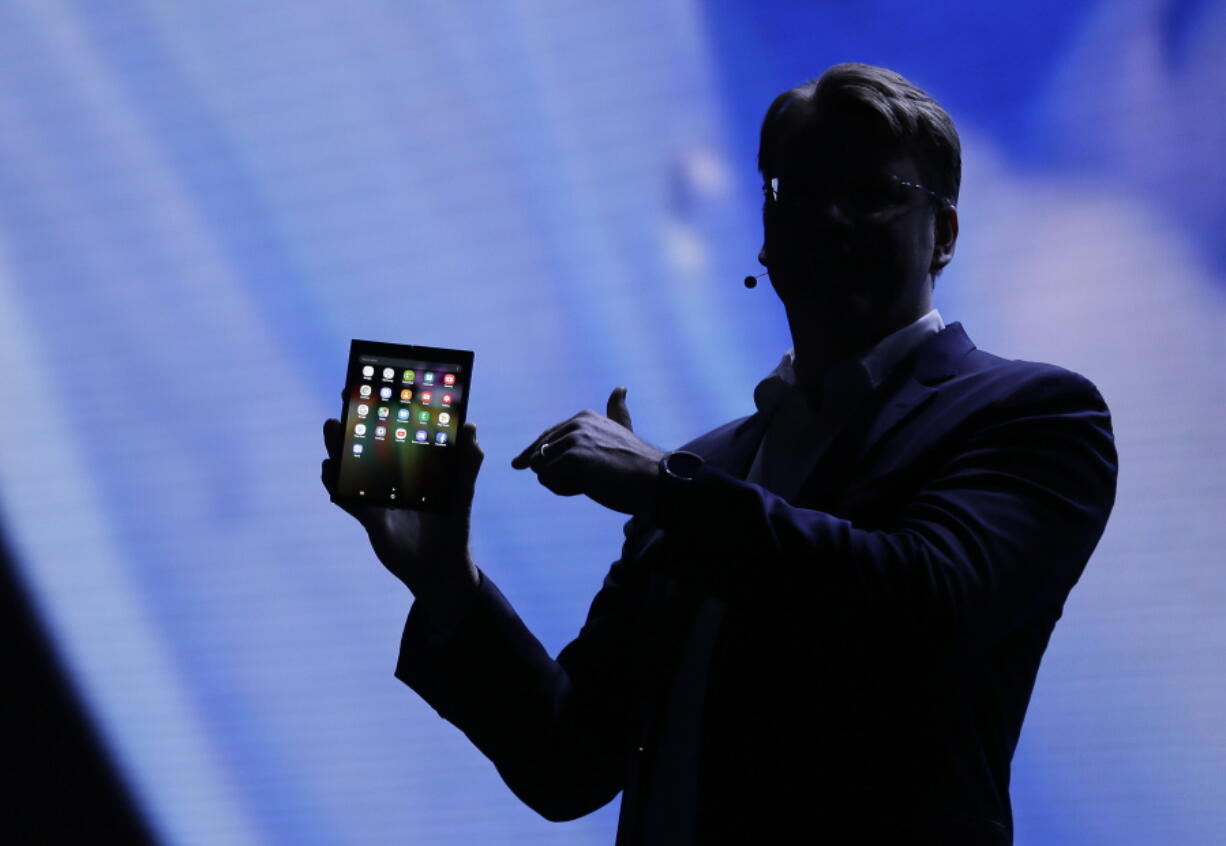 Justin Denison, SVP of Mobile Product Development, shows off the Infinity Flex Display of a folding smartphone during the keynote address of the Samsung Developer Conference Wednesday, Nov. 7, 2018, in San Francisco.