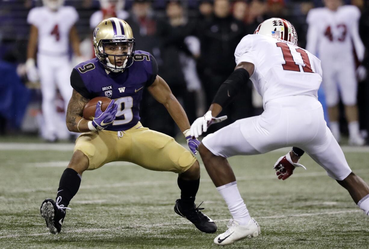 Washington's Myles Gaskin (9) carries as Stanford's Paulson Adebo moves in during the first half of an NCAA college football game Saturday, Nov. 3, 2018, in Seattle.