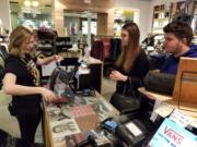 Megan Lackey rings up Mary-Ann and David Onuta at Vans on Thursday evening, Nov.