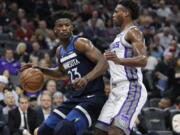 Minnesota Timberwolves guard Jimmy Butler (23) battles for position against Sacramento Kings guard Buddy Hield (24) during the first half of an NBA basketball game in Sacramento, Calif., Friday, Nov. 9, 2018.