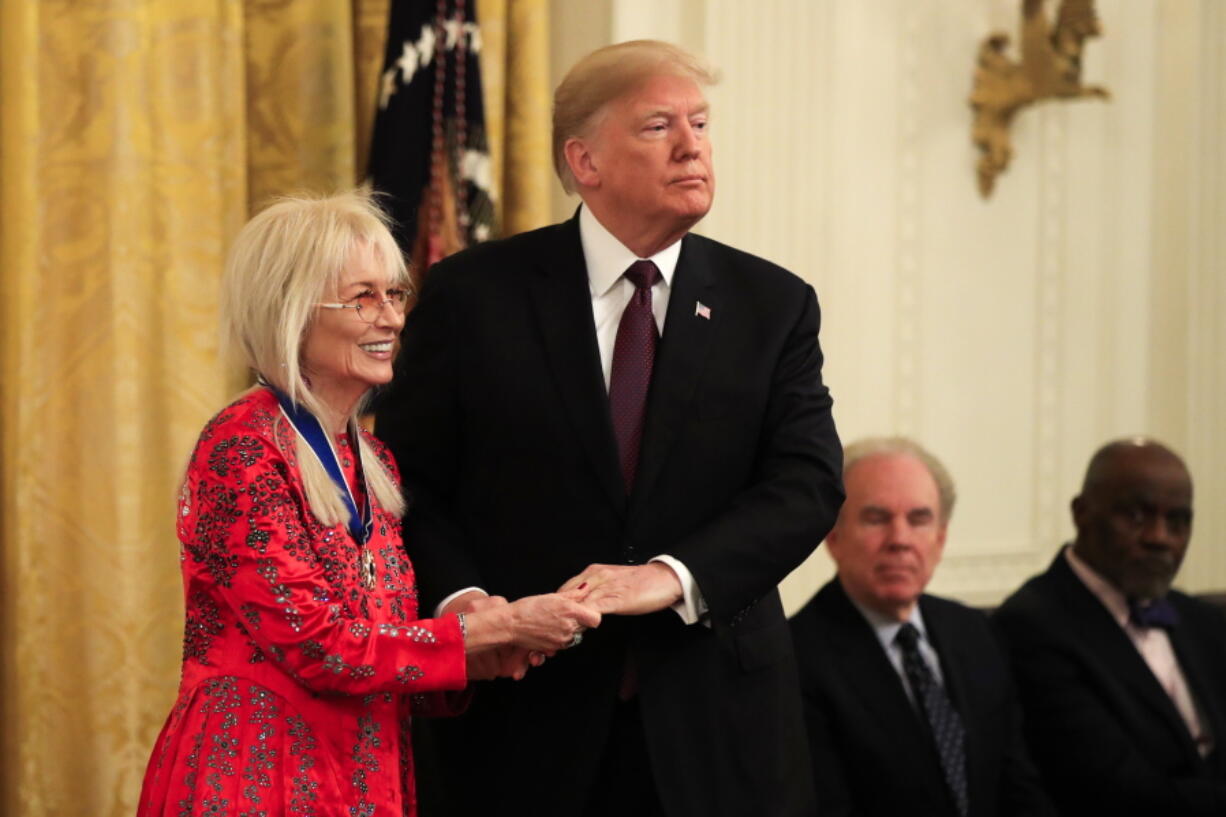 President Donald Trump presents the Presidential Medal of Freedom to Miriam Adelson during a ceremony in the East Room of the White House, in Washington, Friday, Nov. 16, 2018.