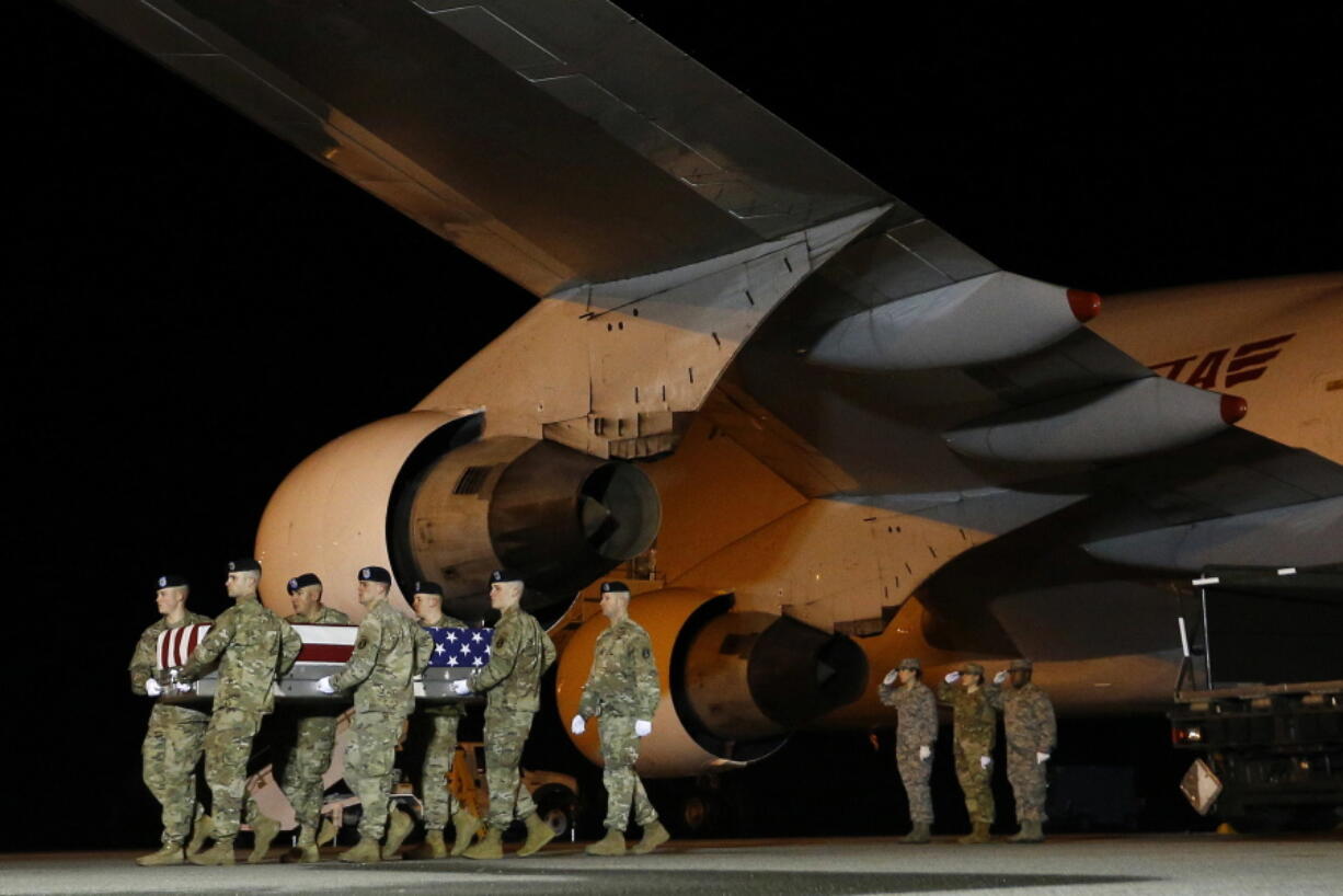 A U.S. Army carry team moves a transfer case containing the remains of Sgt. Leandro A. Jasso, at Dover Air Force Base, Del. A rash of American combat deaths in Afghanistan puts a spotlight on a stalemated 17-year war that is testing President Donald Trump’s commitment to pursuing peace with the Taliban.