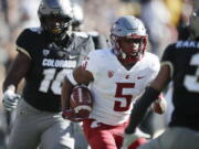 Washington State wide receiver Travell Harris, center, runs for a long gain past Colorado linebacker Alex Tchangam, back, and toward defensive back Derrion Rakestraw in the first half of an NCAA college football game Saturday, Nov. 10, 2018, in Boulder, Colo.