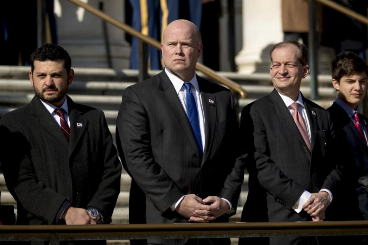 Acting United States Attorney General Matt Whitaker, center, and Labor Secretary Alex Acosta, second from right, attend a wreath laying ceremony at the Tomb of the Unknown Soldier during a ceremony at Arlington National Cemetery on Veterans Day, Sunday, Nov. 11, 2018, in Arlington, Va.