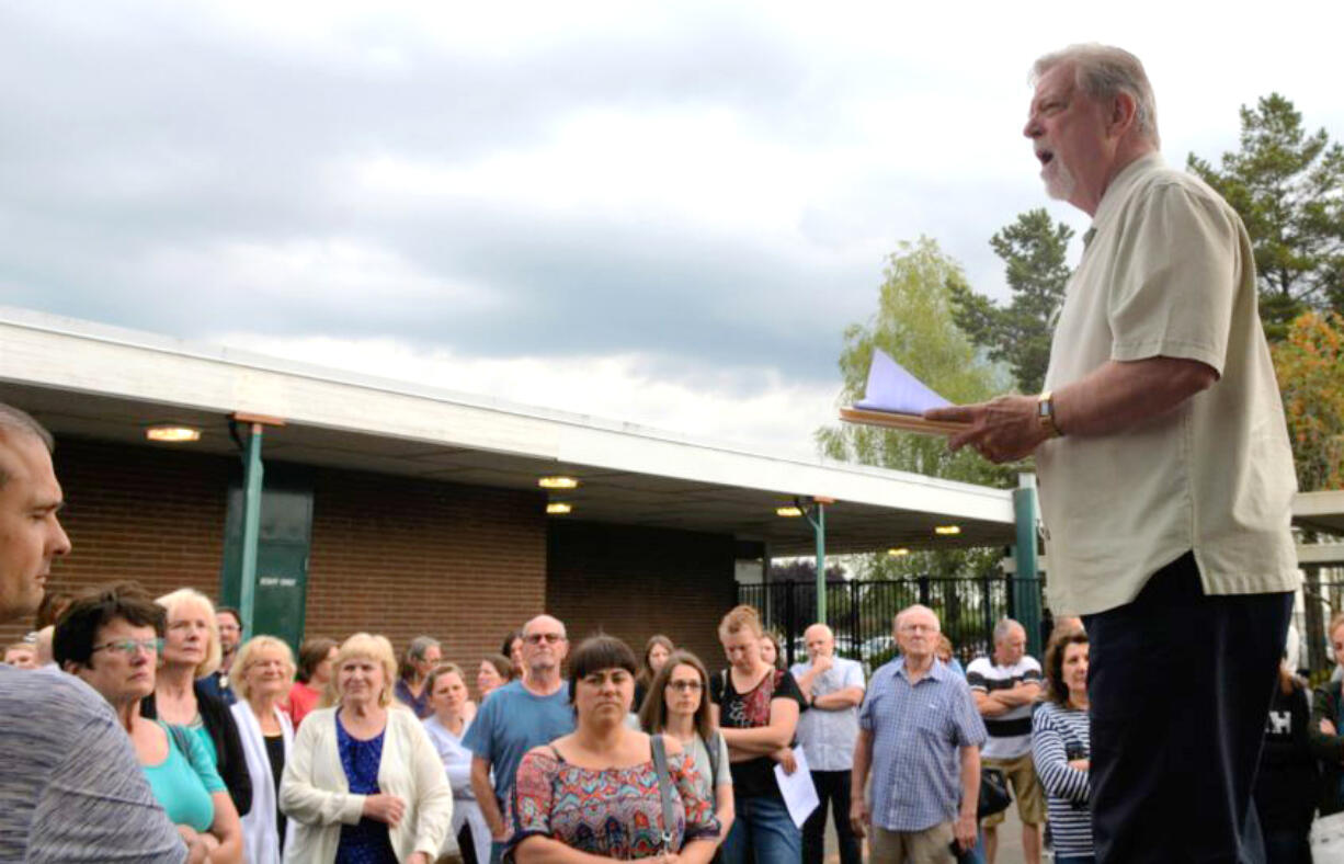 Doug Sheddy speaks to a crowd opposing the adoption of "High School FLASH" in July at Battle Ground Public Schools. Critics of the curriculum say its lessons on gender identity and sexual orientation are not appropriate for children.