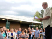 Doug Sheddy speaks to a crowd opposing the adoption of "High School FLASH" in July at Battle Ground Public Schools. Critics of the curriculum say its lessons on gender identity and sexual orientation are not appropriate for children.