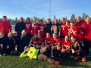 The Camas girls soccer team poses with coach Roland Minder after a 4-2 win over Bellarmine Prep in the 4A state quarterfinals at Doc Harris Stadium. On Saturday, Nov. 10, 2018.