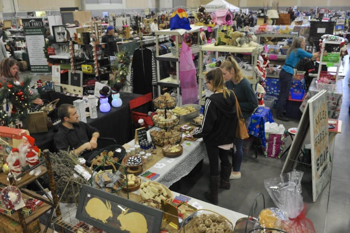 Shoppers look at handmade soaps at the booth for Ayles Herbals on Saturday at the NW’s Largest Garage Sale & Vintage Sale at the Clark County Event Center. It was the final show of the year for the NW’s Largest Garage Sale. The next one, coming up in April, will be the 10th anniversary show.