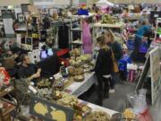 Shoppers look at handmade soaps at the booth for Ayles Herbals on Saturday at the NW’s Largest Garage Sale & Vintage Sale at the Clark County Event Center. It was the final show of the year for the NW’s Largest Garage Sale. The next one, coming up in April, will be the 10th anniversary show.