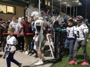 Skyview Storm players walk off the field at Pop Keeney Stadium after Saturday's 34-21 loss to Woodinville in the 4A state playoffs.