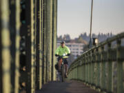 Dan Herrigstad rides his e-bike across the Interstate 5 Bridge as part of his morning commute from his east Vancouver home to the Portland Veterans Affairs Medical Center near the Oregon Health and Science University campus.