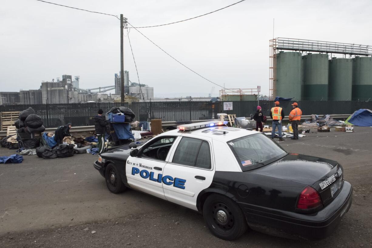 A Vancouver Police Department cruiser is parked next to a homeless encampment near the Vancouver Share House during a Nov. 21 cleanup operation.