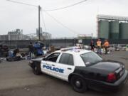 A Vancouver Police Department cruiser is parked next to a homeless encampment near the Vancouver Share House during a Nov. 21 cleanup operation.