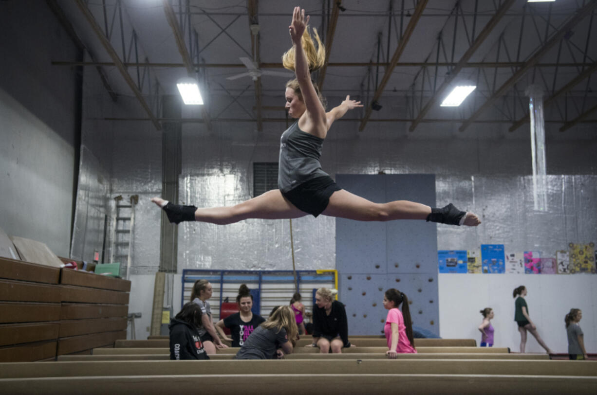 Columbia River senior Grace Gordon does a switch leap for her beam routine at Naydenov Gymnastics in Vancouver.