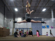 Columbia River senior Grace Gordon does a switch leap for her beam routine at Naydenov Gymnastics in Vancouver.