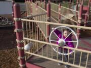 Lucy Flora, 2, turns a steering wheel on the Felida Community Park playground. With its raised platforms and wood chip surfacing, the playground is not accessible to children of all abilities. However, in 2019 or 2020 the county will construct the first all-abilities play area in this park.