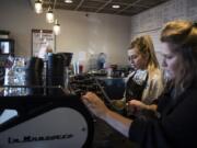 Brittany Tese, left, and Karlee Hofman, right, both of Vancouver, make coffee at Red Barn located in the Erickson Farms retail area. Red Barn opened earlier this year in the new retail area.